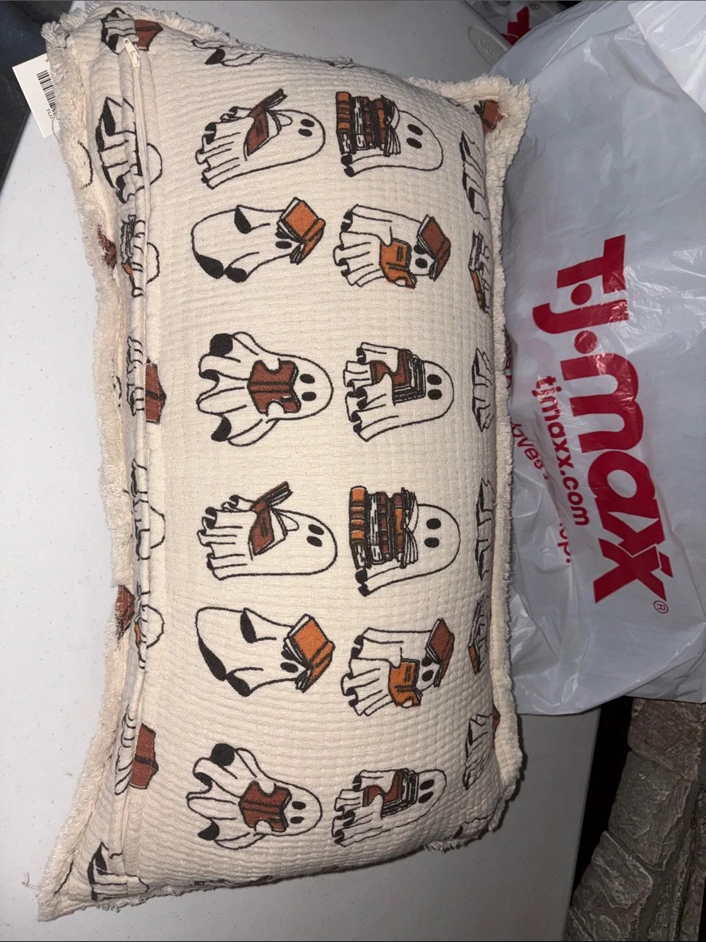 Rachel Zoe Cream reading Ghost Print Throw Pillow with Orange and Black Details